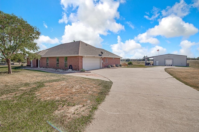 view of side of property with a yard and a garage