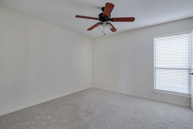 carpeted spare room with ceiling fan and a healthy amount of sunlight