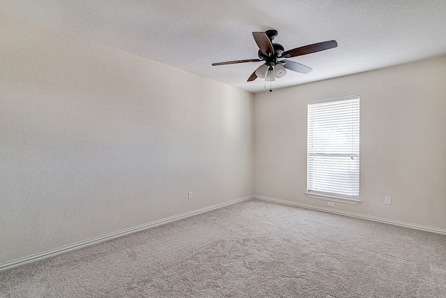 unfurnished room with a textured ceiling, carpet flooring, and ceiling fan