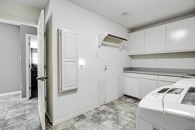 laundry area with cabinets and washer and clothes dryer