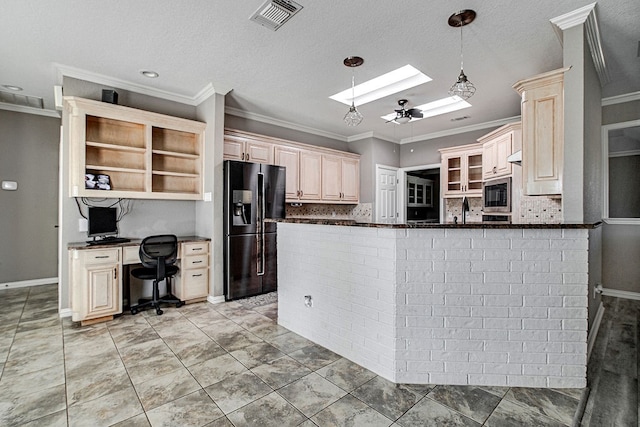 kitchen featuring backsplash, a skylight, black refrigerator with ice dispenser, and kitchen peninsula