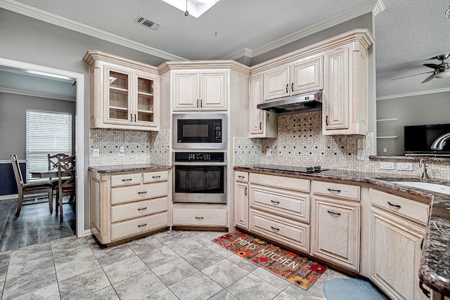 kitchen with black electric stovetop, crown molding, oven, and built in microwave