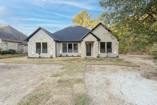 french provincial home with a front yard