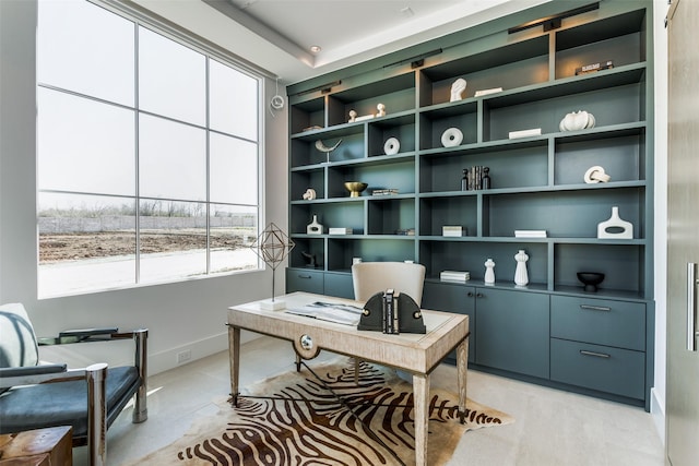 home office featuring built in features and baseboards