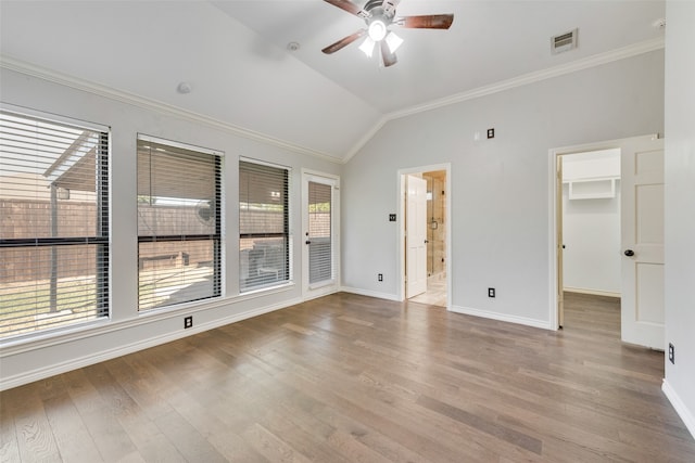 empty room with ceiling fan, lofted ceiling, hardwood / wood-style floors, and a healthy amount of sunlight