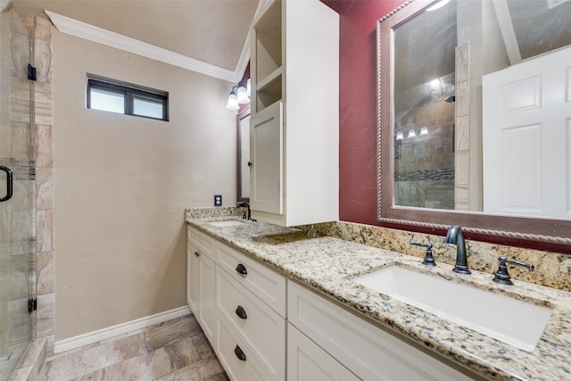 bathroom featuring a shower with shower door, vanity, and ornamental molding