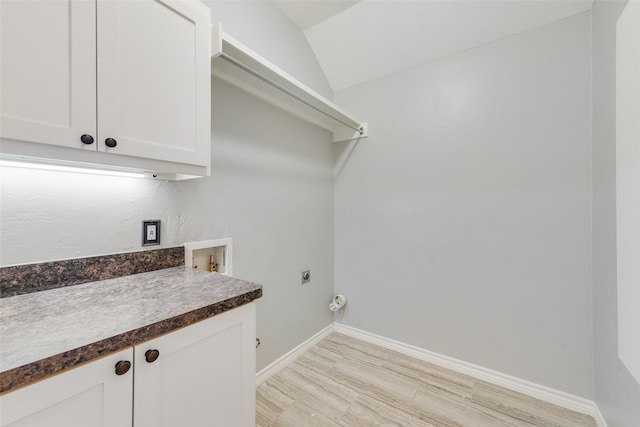 laundry room with cabinets, washer hookup, light hardwood / wood-style flooring, and electric dryer hookup