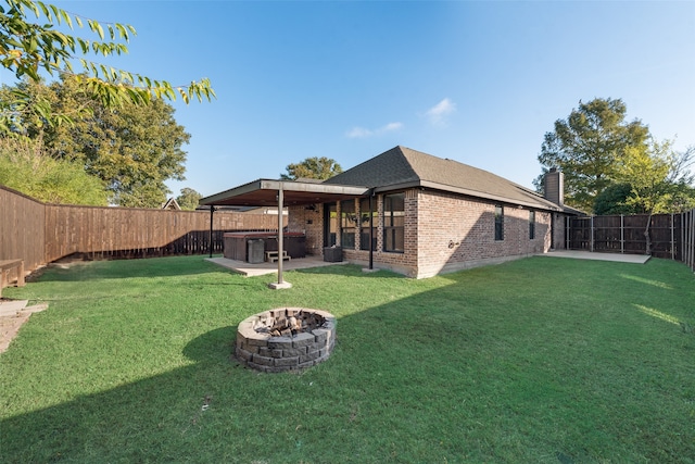 view of yard featuring an outdoor fire pit and a patio