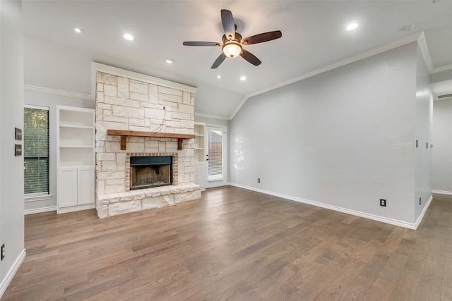 unfurnished living room with hardwood / wood-style floors, a stone fireplace, and plenty of natural light