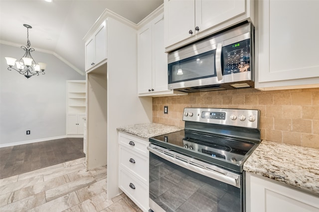 kitchen with tasteful backsplash, appliances with stainless steel finishes, light stone countertops, white cabinets, and lofted ceiling