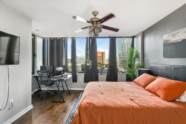1200 Main St Unit 503, Dallas, TX 75202 - bedroom with baseboards, a ceiling fan, and dark wood finished floors