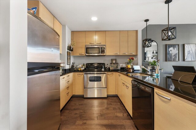 1200 Main St Unit 503, Dallas, TX 75202 - kitchen featuring appliances with stainless steel finishes, dark countertops, a sink, light brown cabinets, and dark wood-type flooring