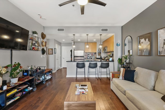 living room featuring dark hardwood / wood-style floors and ceiling fan