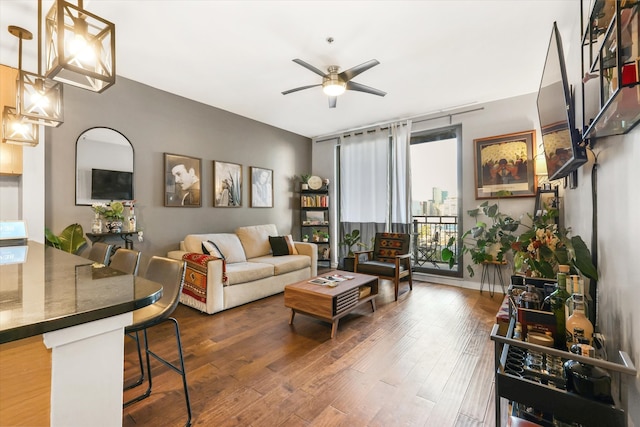 living room with ceiling fan and hardwood / wood-style flooring