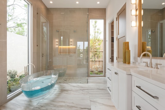 bathroom featuring vanity, recessed lighting, a shower stall, and a freestanding bath