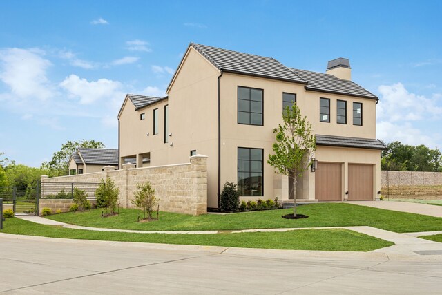 view of front of house featuring a tile roof, a chimney, concrete driveway, fence, and an attached garage