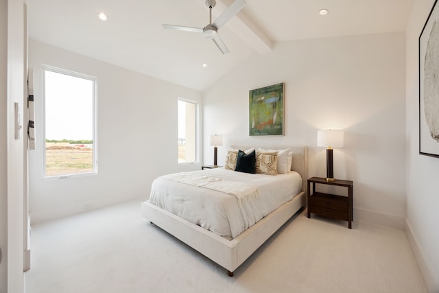 carpeted bedroom with lofted ceiling with beams, a ceiling fan, and baseboards