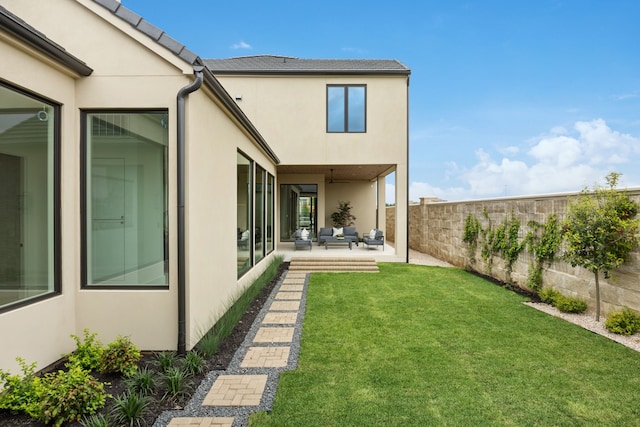 view of yard with a patio area, a fenced backyard, and an outdoor living space