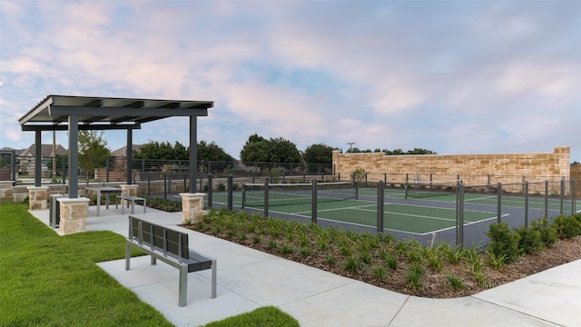 view of sport court featuring fence and a yard