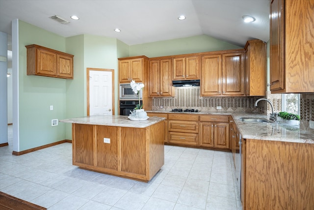 kitchen with lofted ceiling, black appliances, a center island, sink, and light tile patterned floors