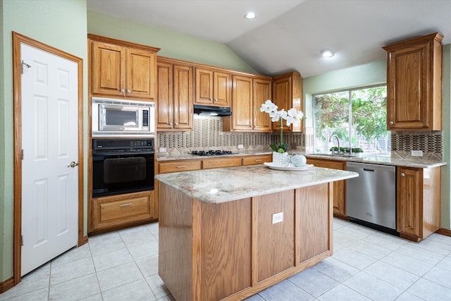 kitchen featuring backsplash, black appliances, vaulted ceiling, and a kitchen island