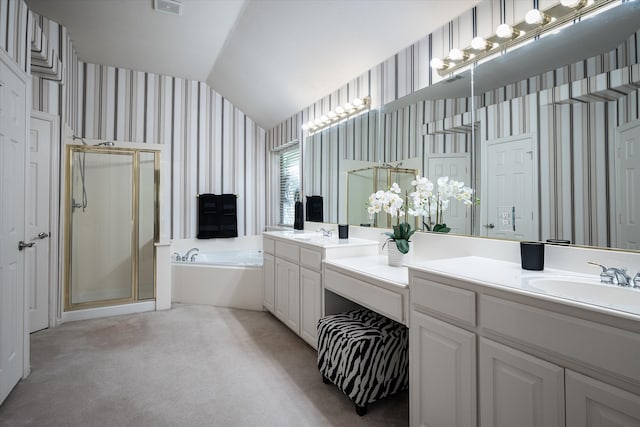 bathroom with vanity, lofted ceiling, and separate shower and tub