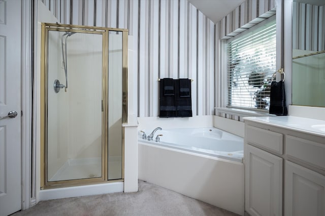 bathroom with vanity and shower with separate bathtub