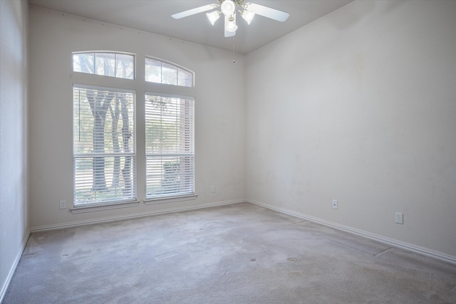 carpeted empty room featuring ceiling fan