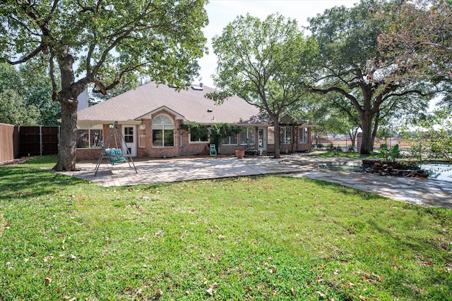 back of property featuring a patio and a lawn