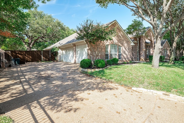 view of front of property featuring a garage and a front lawn