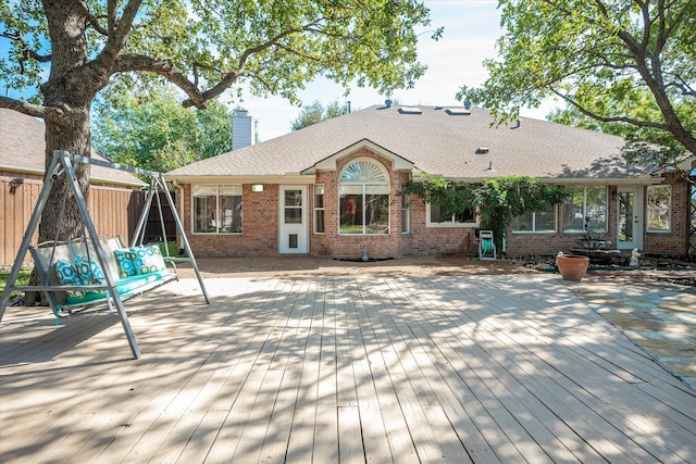 back of property featuring a wooden deck