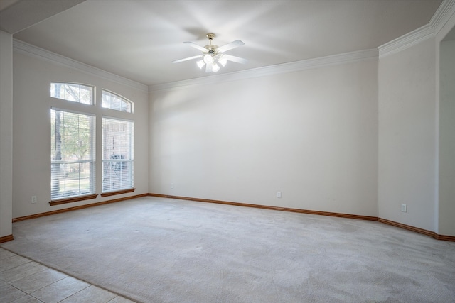 empty room featuring crown molding, ceiling fan, light carpet, and plenty of natural light