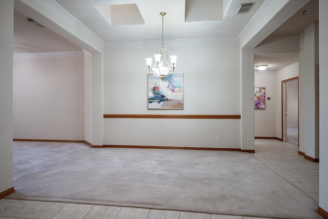 carpeted spare room featuring a skylight, ornamental molding, and an inviting chandelier