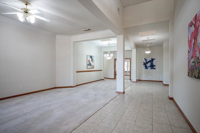 carpeted spare room featuring ornamental molding and ceiling fan with notable chandelier