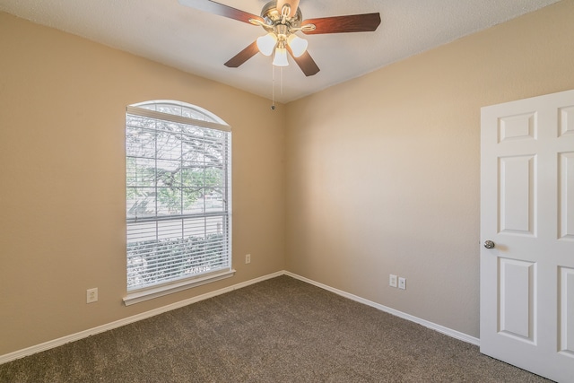 carpeted spare room with ceiling fan