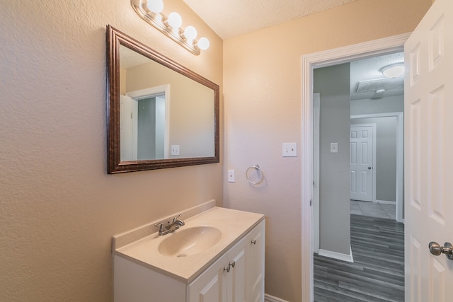 bathroom featuring vanity, a textured ceiling, and wood-type flooring