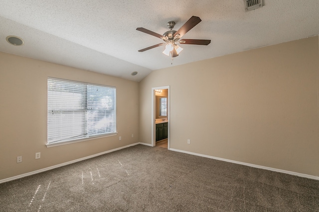 spare room featuring ceiling fan, a textured ceiling, carpet flooring, and lofted ceiling