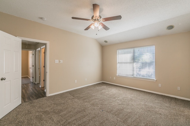 carpeted empty room featuring lofted ceiling, a textured ceiling, and ceiling fan