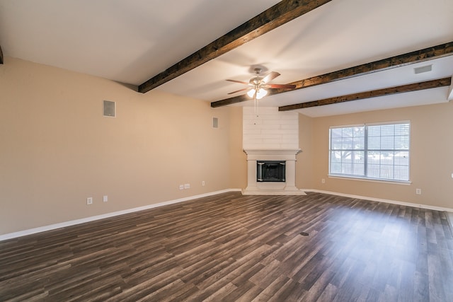 unfurnished living room featuring beam ceiling, ceiling fan, a large fireplace, and dark hardwood / wood-style flooring