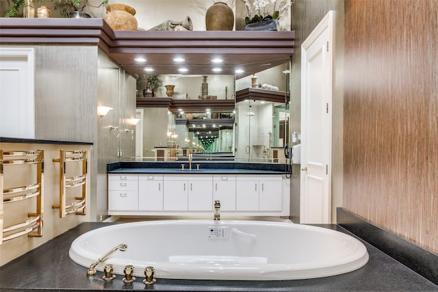 bathroom featuring vanity and a washtub