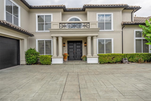 entrance to property with a balcony and a garage