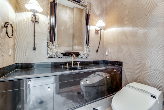 bathroom featuring tile patterned flooring, vanity, and toilet