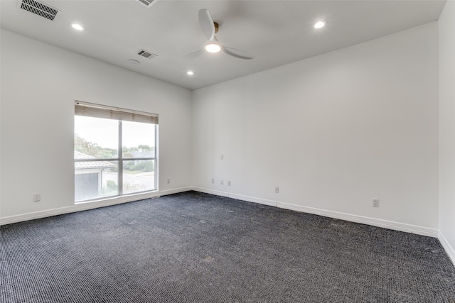 carpeted spare room featuring ceiling fan