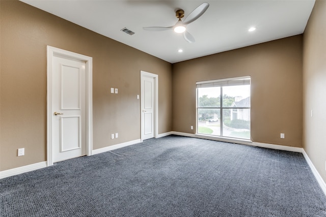 carpeted spare room featuring ceiling fan