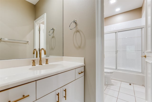 full bathroom featuring shower / bath combination with glass door, vanity, toilet, and tile patterned flooring