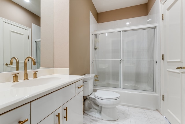 full bathroom with vanity, toilet, and bath / shower combo with glass door