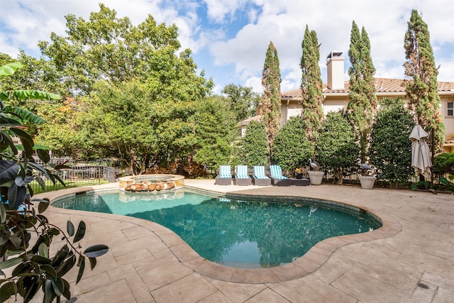 view of swimming pool with a patio area and an in ground hot tub