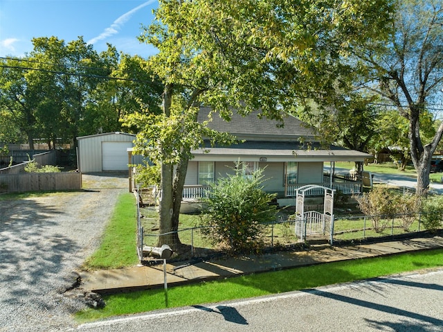 view of front of house with a garage, an outdoor structure, and a porch