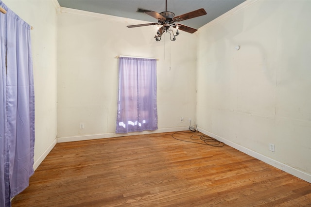 spare room with ornamental molding, ceiling fan, and light hardwood / wood-style floors