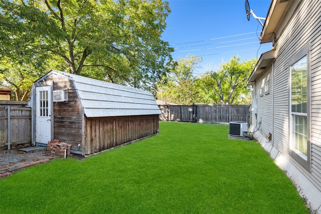 view of yard with central AC and a shed